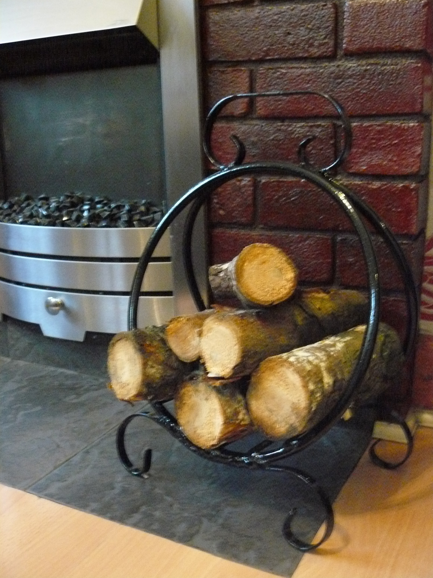 Round log basket hand made by wimborne wrought iron works