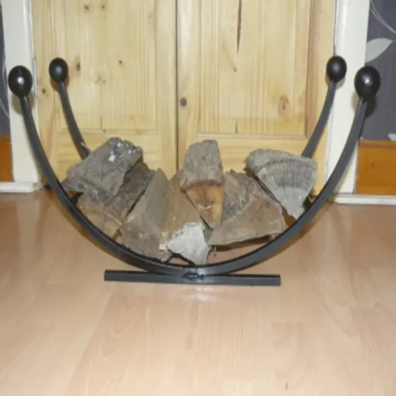 Curved log basket with ball finals Wimborne wrought iron works